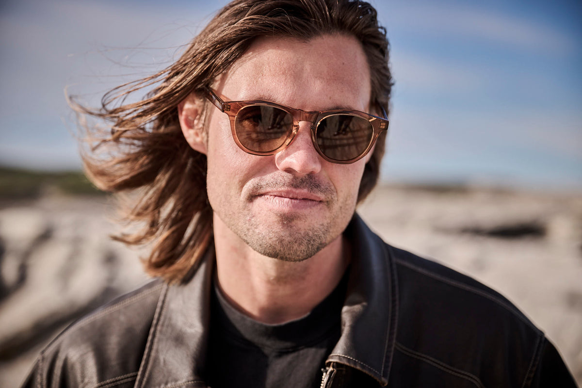 Kipp Caddy wearing translucent brown Childe sunglasses